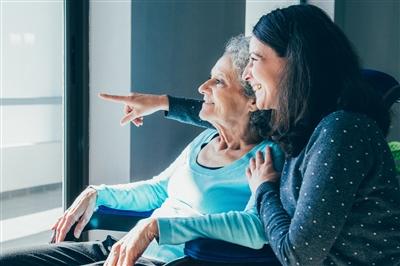 Middle aged woman taking care of mother