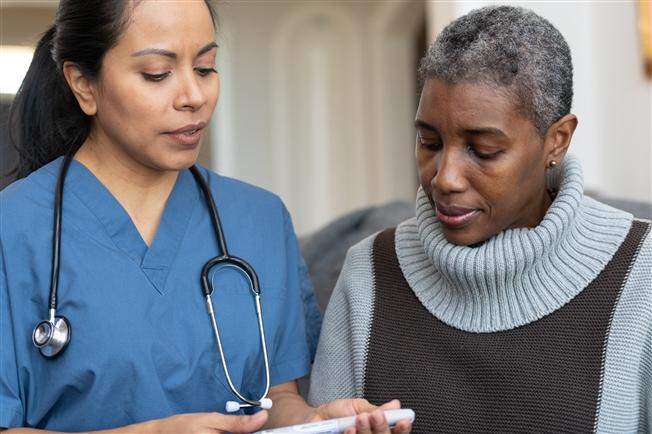Woman talking to nurse