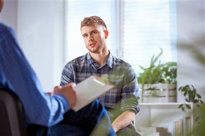 Man in one-on-one therapy Man in one-on-one therapy