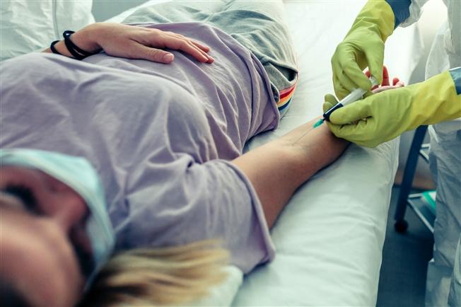 Doctor drawing blood from patient's arm