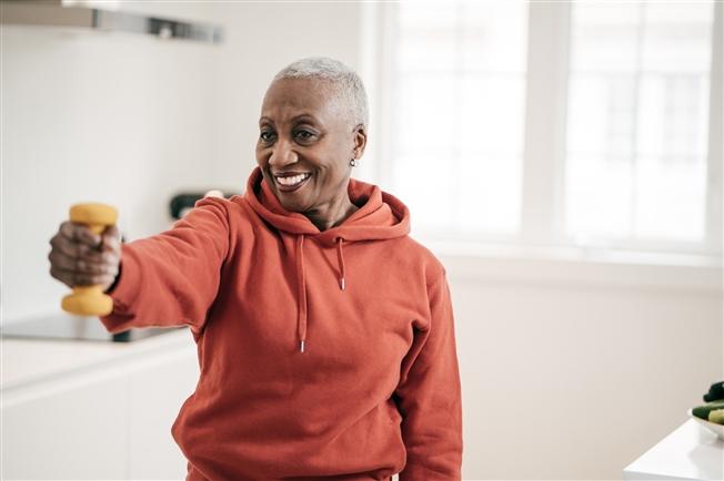 Senior women taking care of herself she exercise with dumbbells at home Senior women taking care of herself she exercise with dumbbells at home