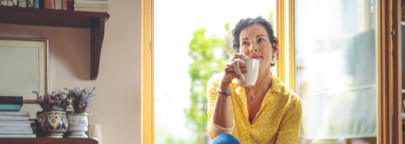 Mature woman is having the morning coffee at home