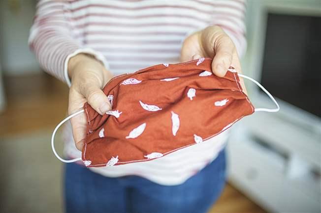 Young woman shows selfmade mask to protect against viruses and bacteria