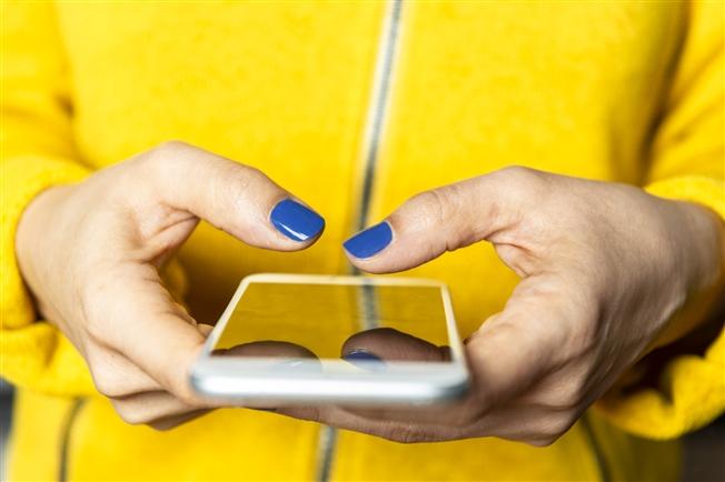 Close up of adult woman using cell phone