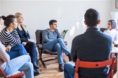 Woman speaking in group therapy session