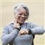 Senior woman exercising taking pulse
