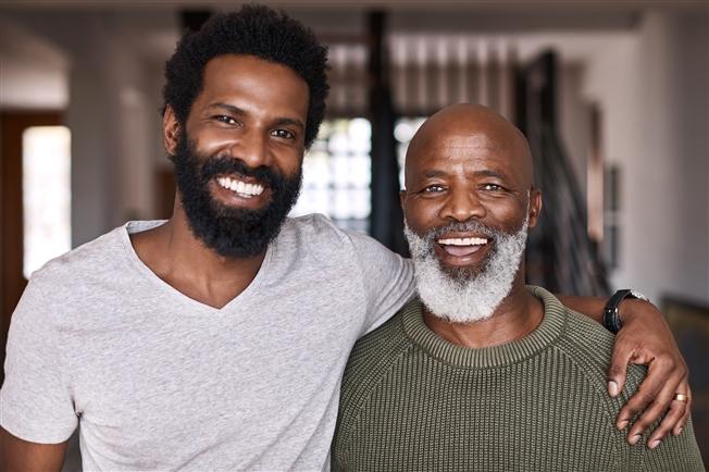 Adult man with arm around dad a senior man Adult man with arm around dad a senior man