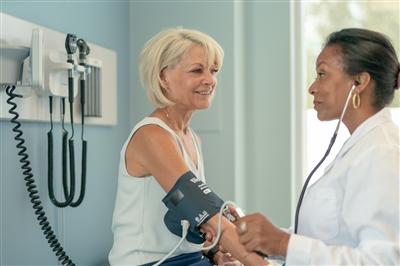 Mature adult woman in medical consultation with female doctor Mature adult woman in medical consultation with female doctor
