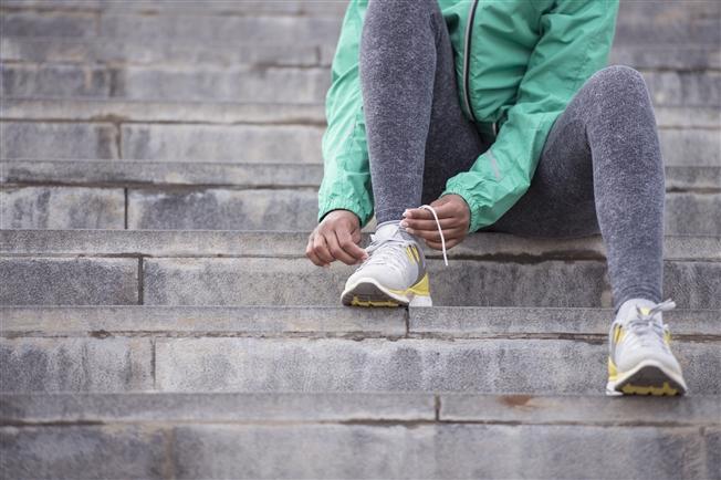 Close up of woman lacing up running shoes