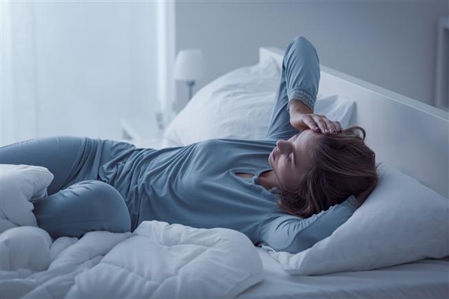 Woman in bed awake at night