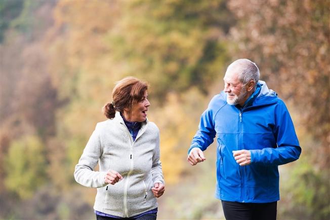 Mature older couple exercising outside together Mature older couple exercising outside together