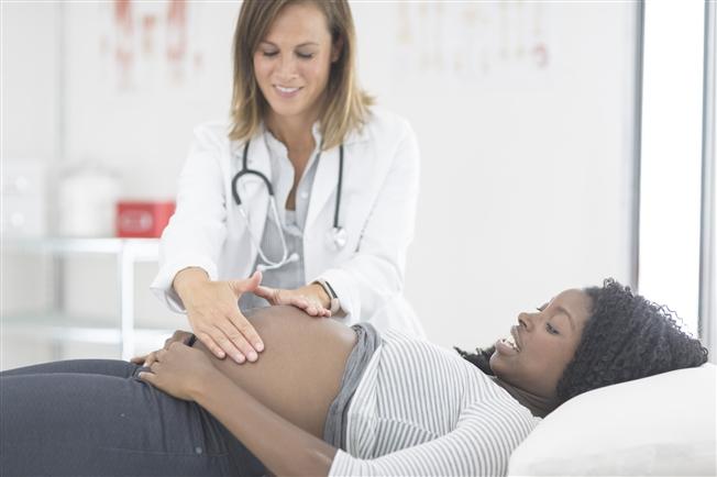 Pregnant woman at check up with female doctor