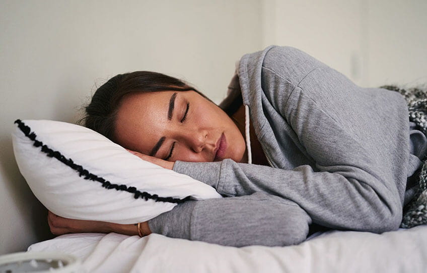 Woman sleeping peacefully in bed