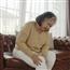 woman holding leg in pain