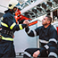 Firefighter giving another firefighter supportive handshake