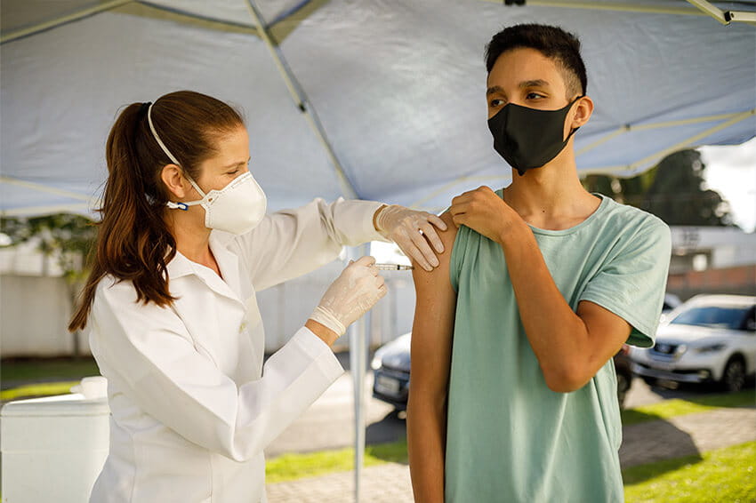 teenage boy receiving vaccination