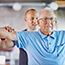 Older man strength training with therapist