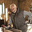 Older man in workshop with low back pain
