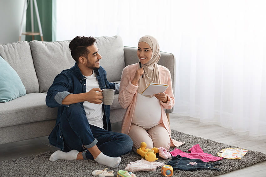 Pregnant Muslim woman planning with male partner