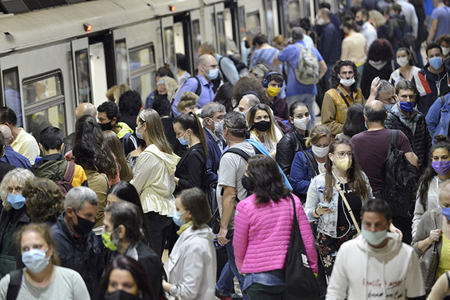 Busy subway station with people wearing masks