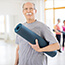 Older man with yoga mat