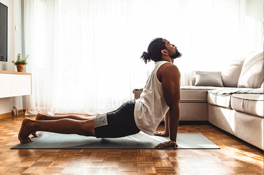 Young guy doing yoga stretch