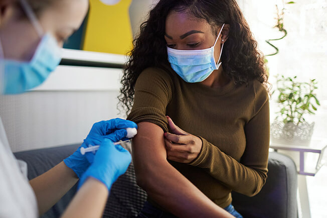 Young woman receiving vaccination