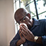 older man blowing nose