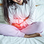girl holding belly from pelvic floor issues