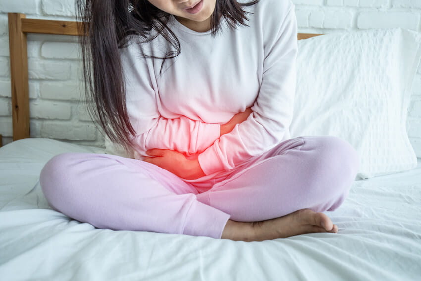 girl holding belly from pelvic floor issues