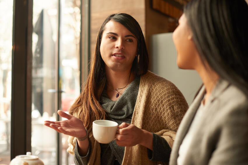 Transgender person talking with cis gendered person