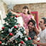 gay male couple with daughter decorating tree