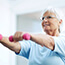 older adult woman using free weights