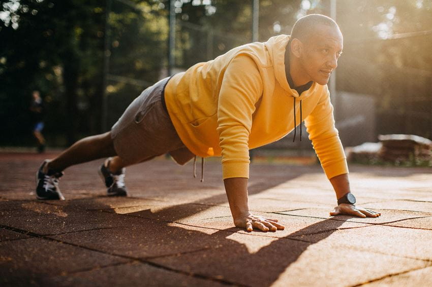 Middle aged man exercising outside on a sunny day