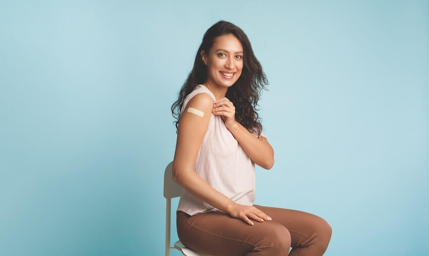 woman showing off vaccine arm