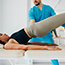 Therapist working with woman doing exercise