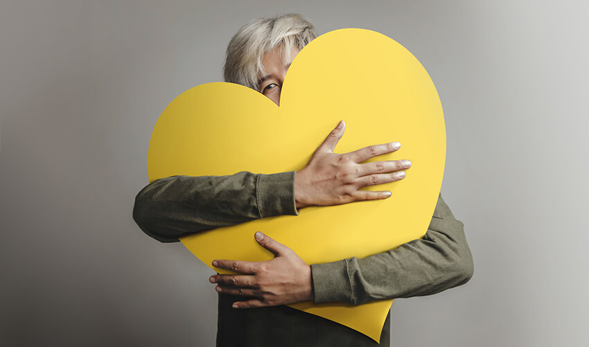 Person holding a paper heart
