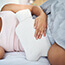 Woman laying on bed in pain