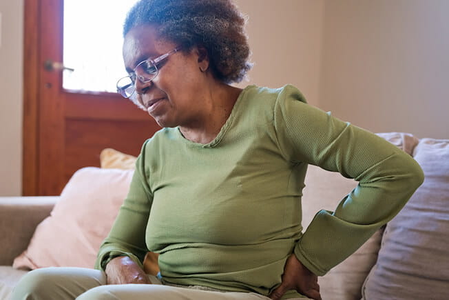 woman holding back/hip pain