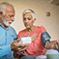 Senior couple using device to measure blood pressure