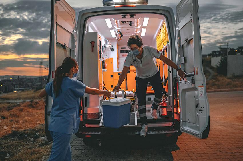 Medical team in a hurry carrying organ transplants box by ambulance