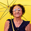 Elderly woman using umbrella for shade