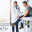 doctor examining his patient who is concerned about his knee