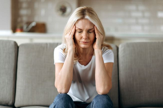 woman holding her head