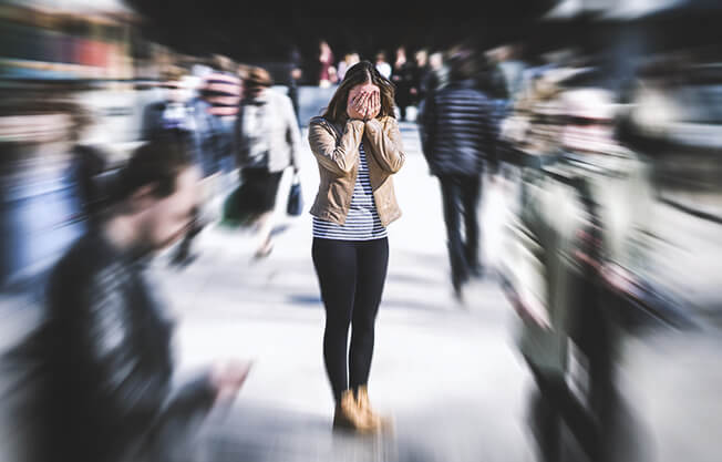 Woman in crowd with social anxiety