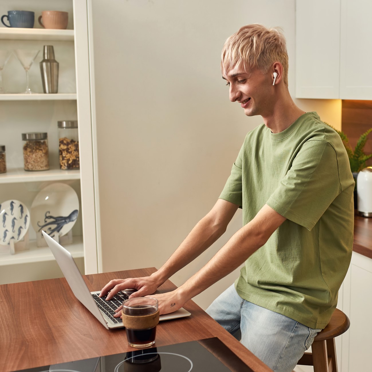 Happy caucasian male working in modern kitchen 