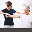 female physical therapist working with a senior male patient