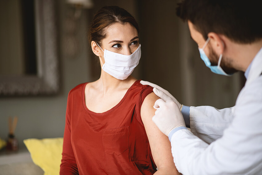 Young woman with rolled sleeve for flu shot
