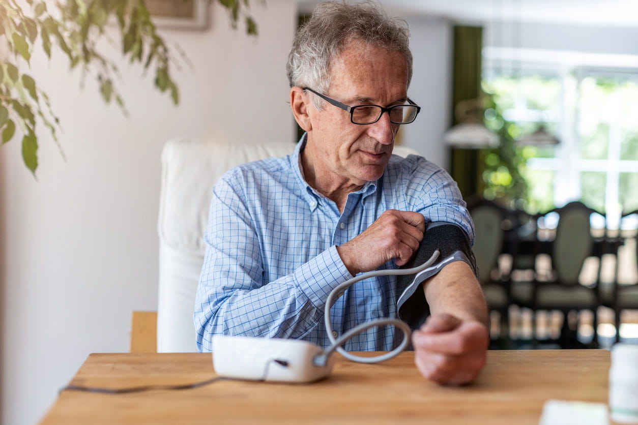 Senior man using medical device