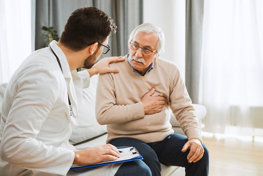 Young doctor and senior man having a conversation about heart condition